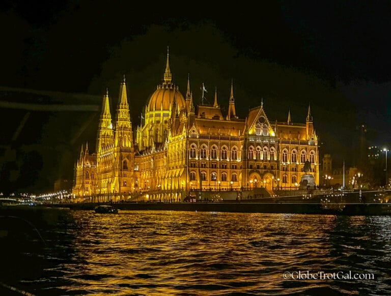 Hungarian Parliament building in Budapest Hungary lit up at night seen from the Danube River