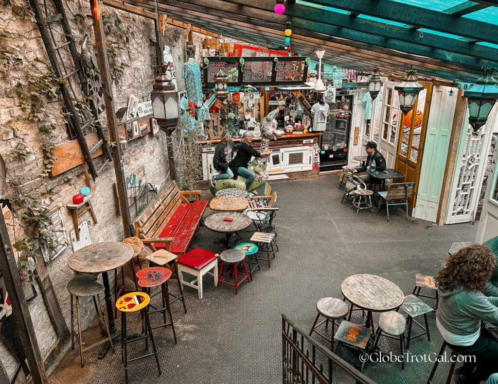 A room in a bar with colorful mismatched furniture at Szimpla Kert, a ruin pub in Budapest Hungary