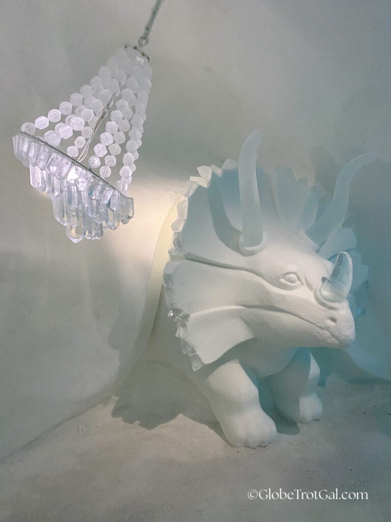 A triceratops carved of ice and a chandelier carved of ice at the Icehotel in Jukkasjärvi, Sweden