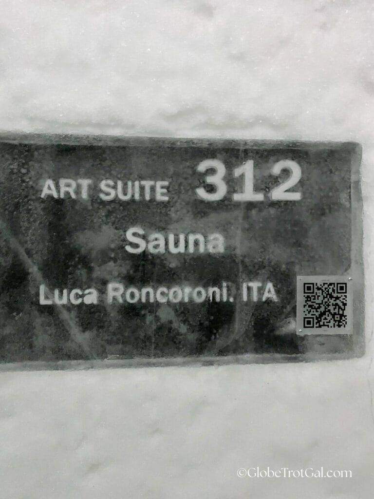 Room sign to art suite 312 identifying the name of the room "Sauna" and the artist who created it at the Icehotel in Jukkasjärvi, Sweden