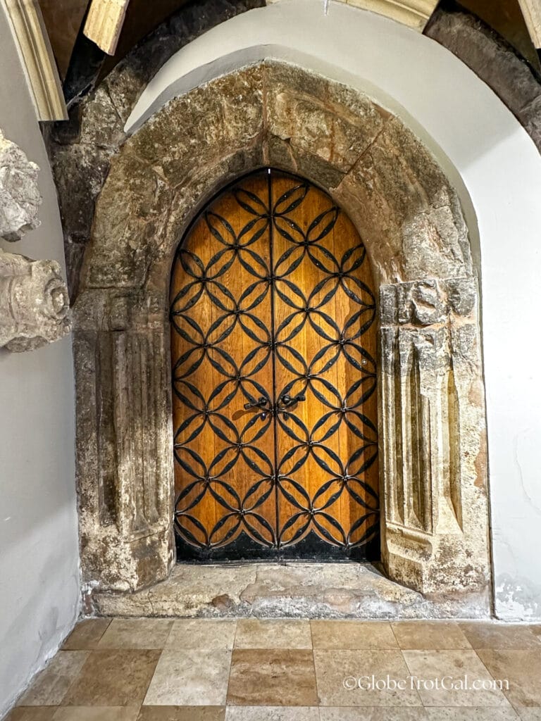 13th century dominican cloister stone doorway arch with a modern wooden door inside it in the Hilton in Budapest Hungary