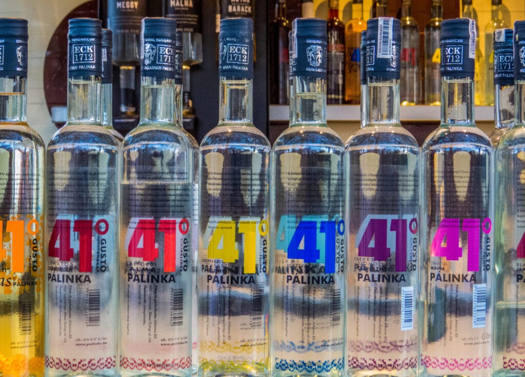 Bottles of Palinka, traditional Hungarian brandy, a popular Budapest souvenir, displayed in a shop window in Budapest, Hungary