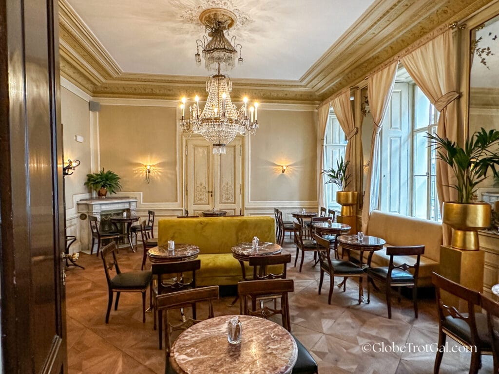 Dining room with large Murano glass chandelier at Cafe Demel in Wien, Austria