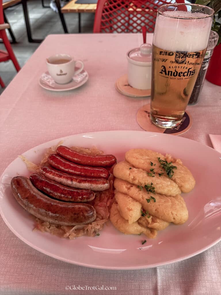 Plate of sausages and mashed potatoes and a beer at a restaurant in Munich