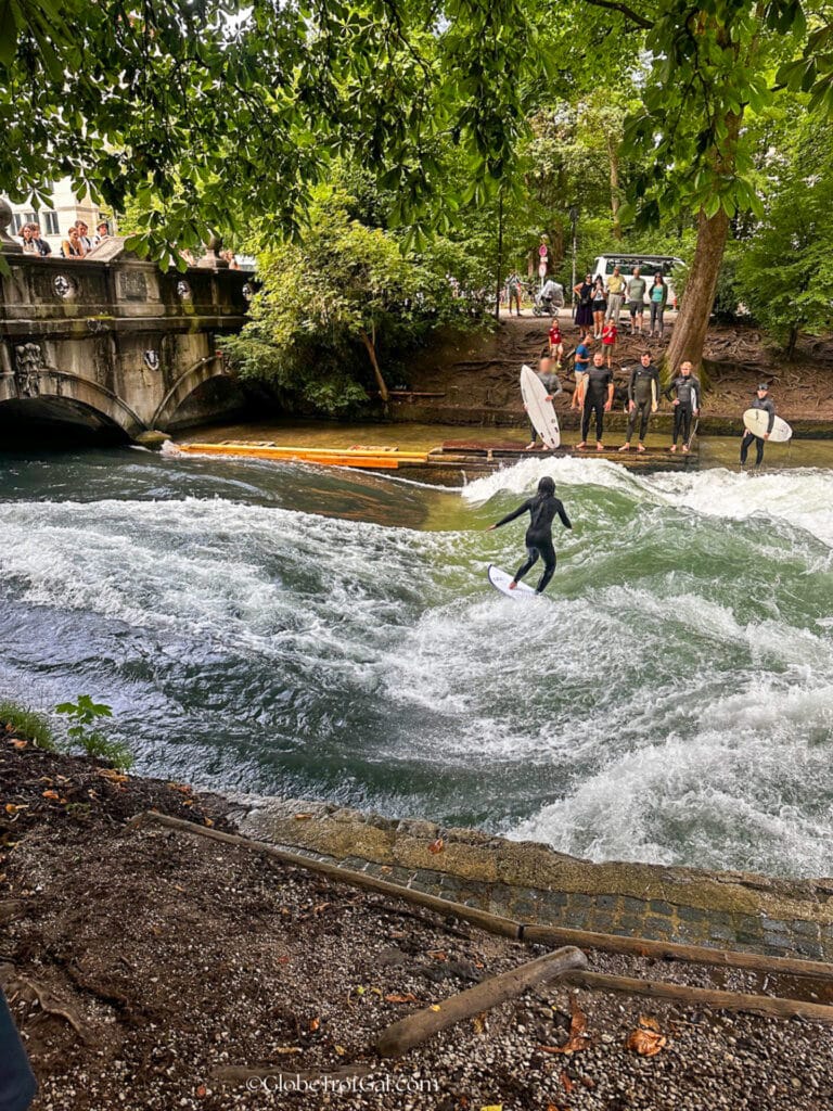 Surfers on the Eisbach river in Munich Germany