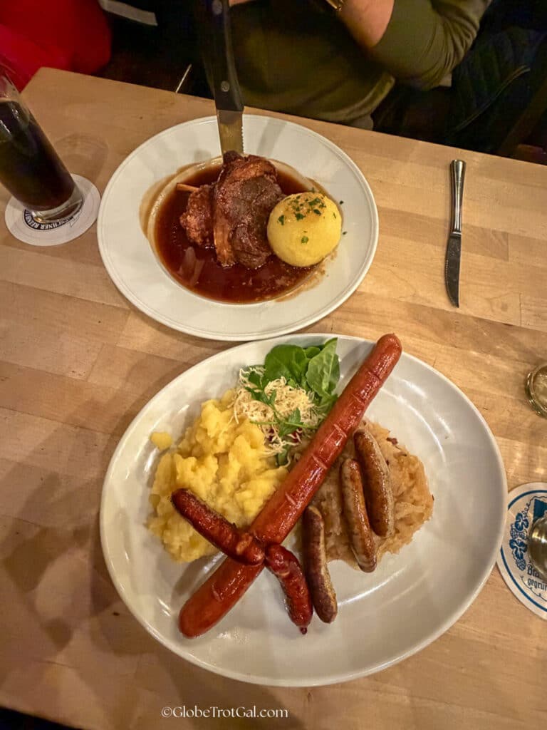 Pork knuckle and sausage plate with sauerkraut in Munich Germany